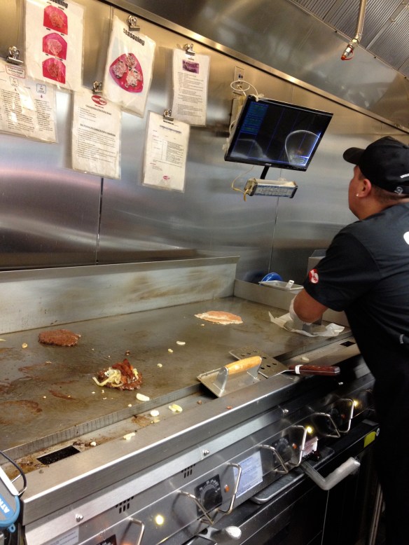 An Angus meat ball getting smashed into a burger