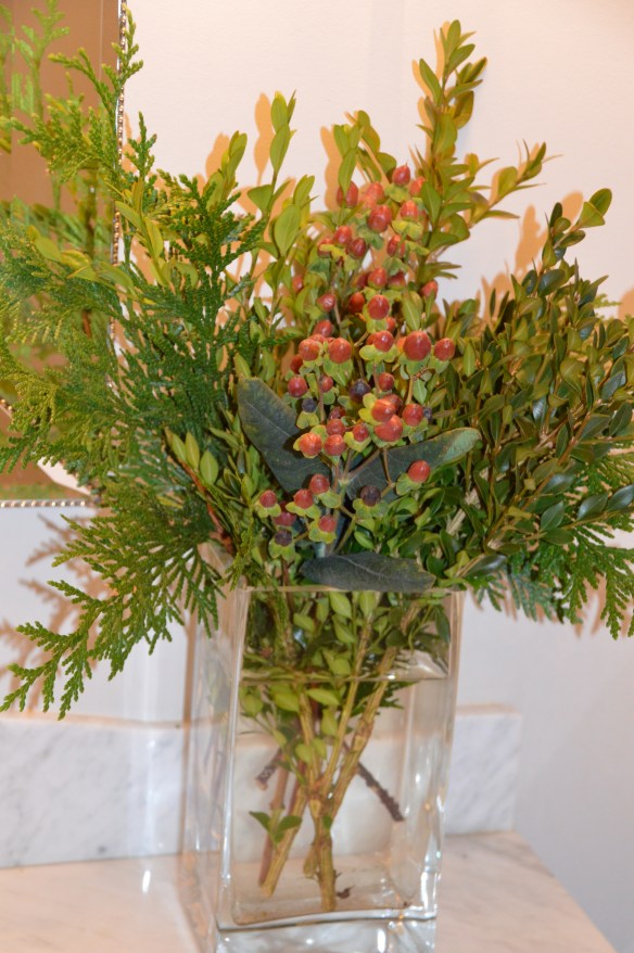 Inexpensive (yet chic!) arrangement of backyard greens and grocery store hypericum berries.