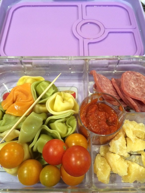 Cold (leftover) cheese tortellini, parmesan cheese chunks, cherry tomatoes, pasta sauce and salami slices.